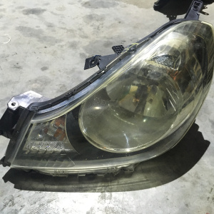 Фара NISSAN лев Y12 деф.крепл