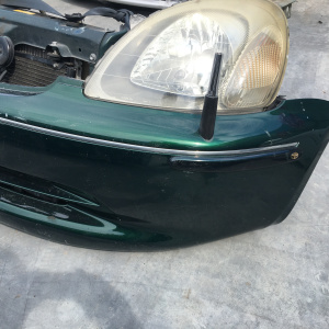 Ноускат Toyota Vitz NCP15 1NZ '1999-2001 a/t (CLAVIA) дефект крепления R фары ф.52-001